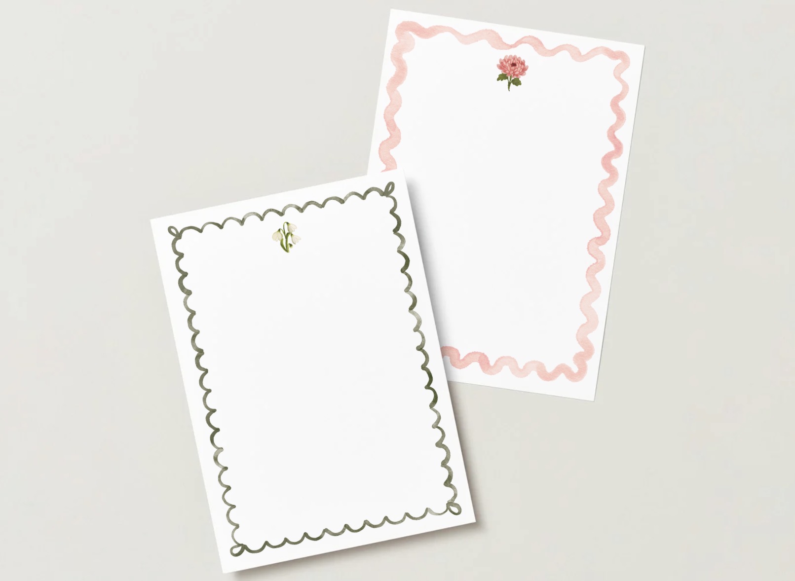 January and November birth flower A7 flat cards, one with a scalloped green border and a snowdrop, one with a wavy pink border and a chrysanthemum, on a pale gray background