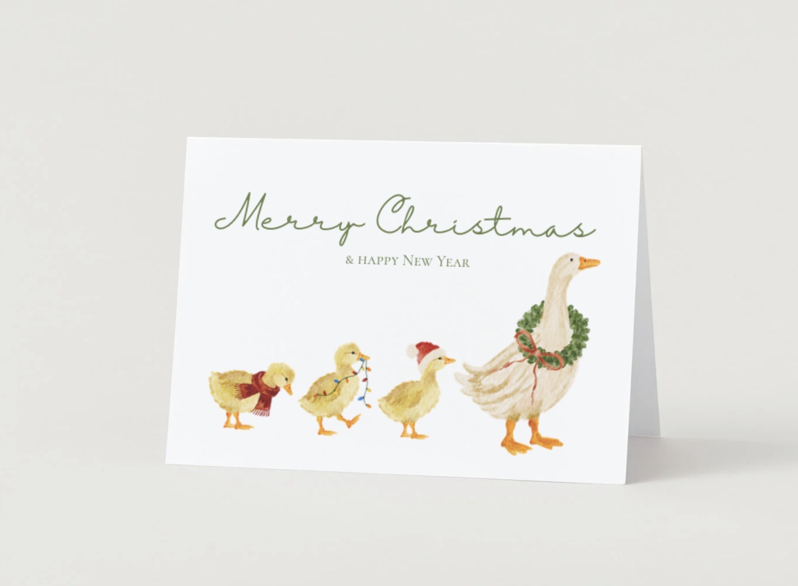 Merry Christmas boxed card with a goose family lineup, mama goose wearing a wreath